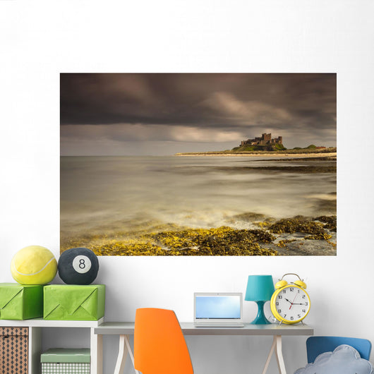 Bamburgh Castle Under A Cloudy Sky Wall Mural