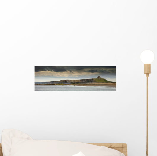 Dunstanburgh Castle On A Hill Under A Cloudy Sky Wall Mural