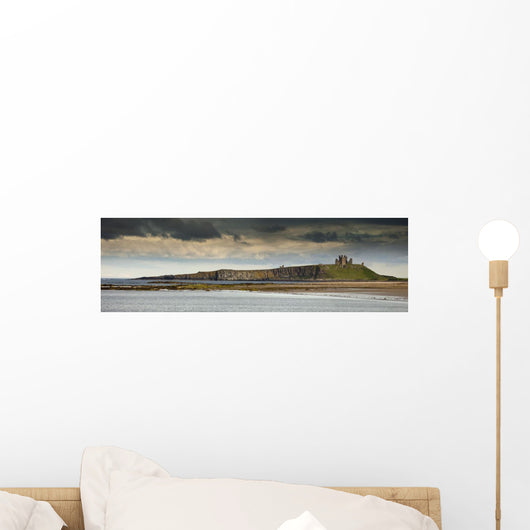Dunstanburgh Castle On A Hill Under A Cloudy Sky Wall Mural