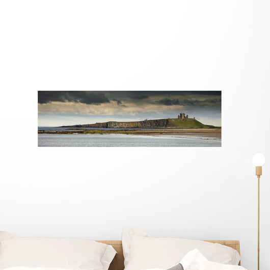 Dunstanburgh Castle On A Hill Under A Cloudy Sky Wall Mural