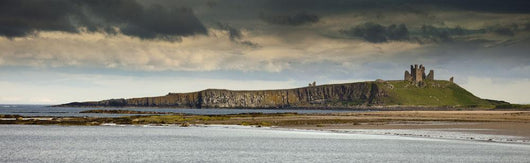Dunstanburgh Castle On A Hill Under A Cloudy Sky Wall Mural