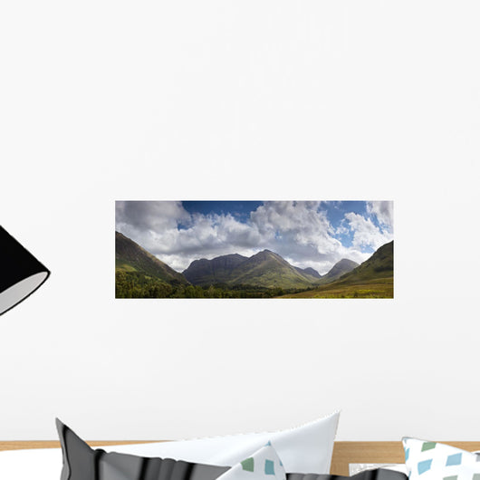 A Mountainous Landscape Under Clouds Wall Mural
