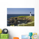 White Lighthouse On The Ocean With Blue Sky And Wildflowers Wall Mural
