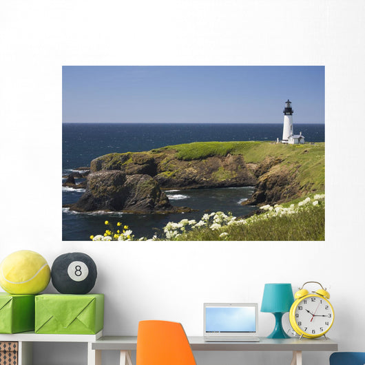 White Lighthouse On The Ocean With Blue Sky And Wildflowers Wall Mural