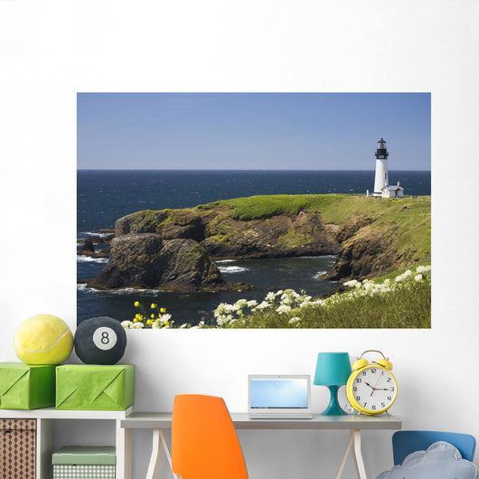 White Lighthouse On The Ocean With Blue Sky And Wildflowers Wall Mural