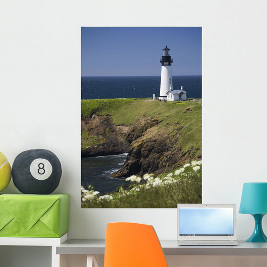 White Lighthouse On The Ocean With Blue Sky And Wildflowers Wall Mural