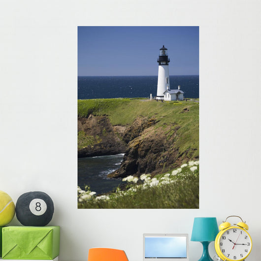 White Lighthouse On The Ocean With Blue Sky And Wildflowers Wall Mural