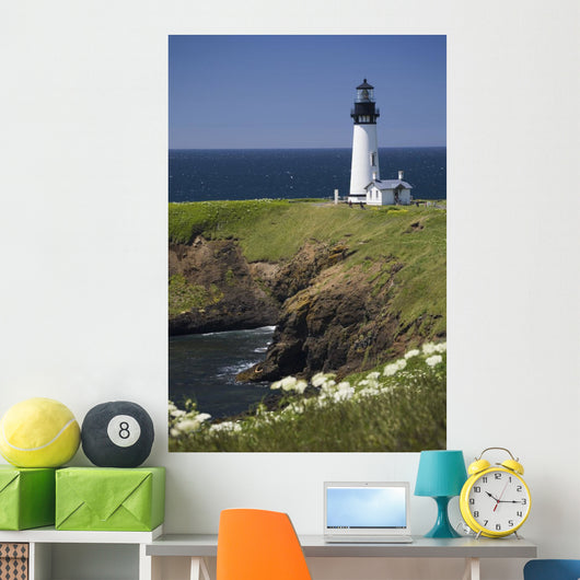 White Lighthouse On The Ocean With Blue Sky And Wildflowers Wall Mural