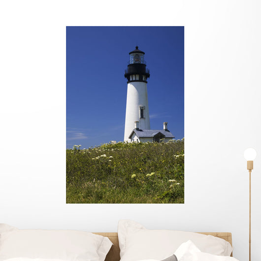 White Lighthouse With A Blue Sky And Wildflowers Wall Mural