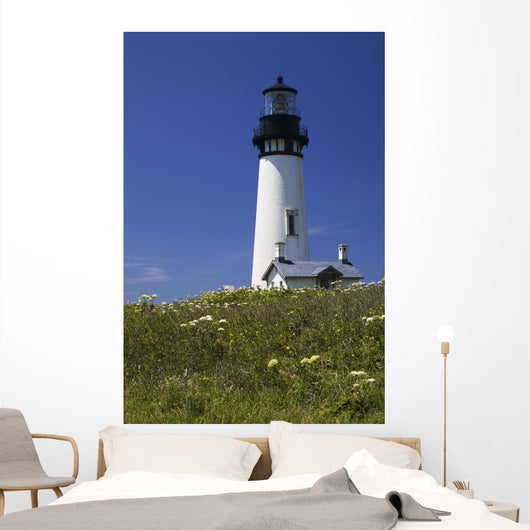 White Lighthouse With A Blue Sky And Wildflowers Wall Mural