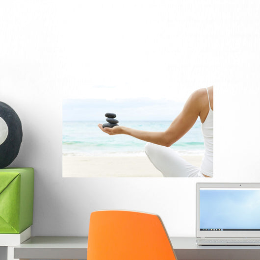 Hawaii, Woman Holding Stack Of Stones In Hands, Ocean In Background Wall Mural