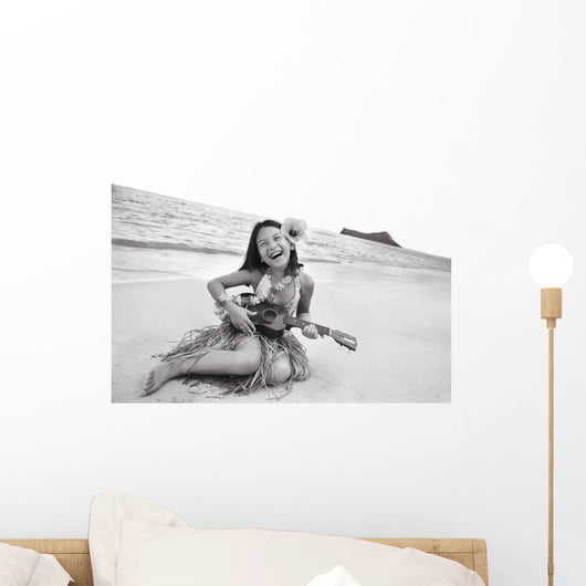 Young Girl Smiling And Playing Ukulele On The Beach In A Hula Skirt Wall Mural