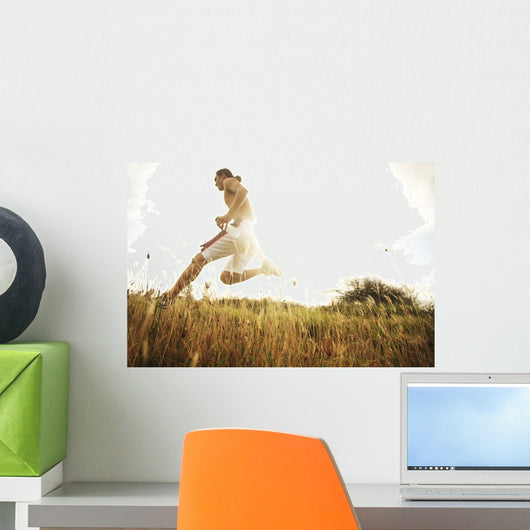 Hawaii, Oahu, Atheltic Male Jogging On An Outdoor Field Walkway Path Wall Mural