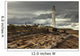 A Lighthouse And Piles Of Logs On The Shore Wall Mural