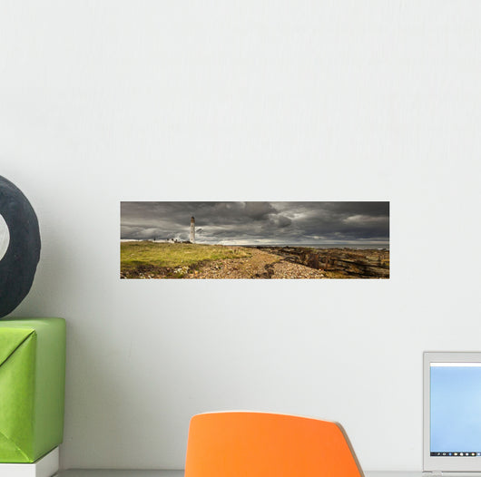 A Lighthouse And Piles Of Logs On The Shore Wall Mural