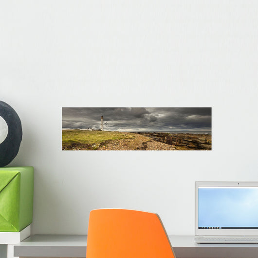A Lighthouse And Piles Of Logs On The Shore Wall Mural