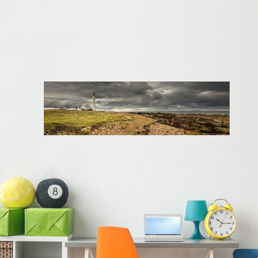 A Lighthouse And Piles Of Logs On The Shore Wall Mural
