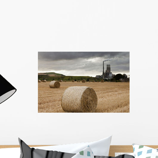 A Cement Production Plant With Hay Bales In A Field In The Foreground Wall Mural