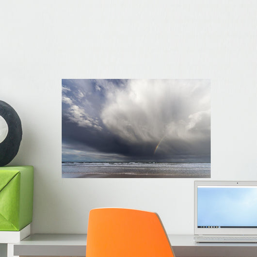 A Rainbow In The Dark Clouds Over The Ocean Wall Mural