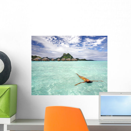 Woman Floating In Water Near Resort Wall Mural