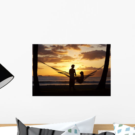 Silhouette Of Woman In Hammock And Man Standing Next To Her Wall Mural