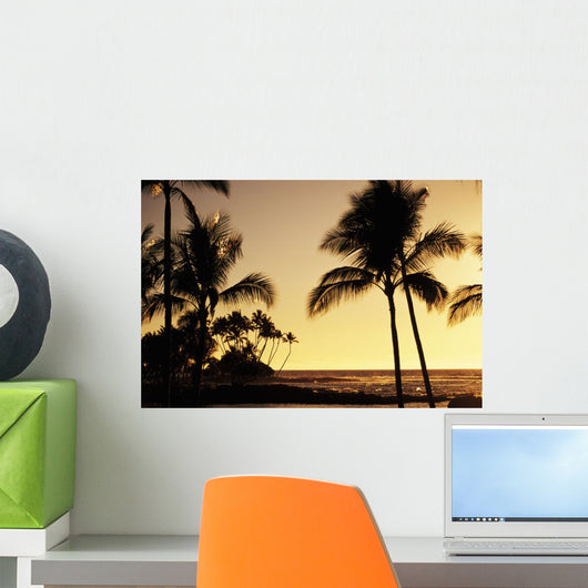 Ocean and silhouetted palm trees at sunset in Mauna Lani Resort Wall Mural