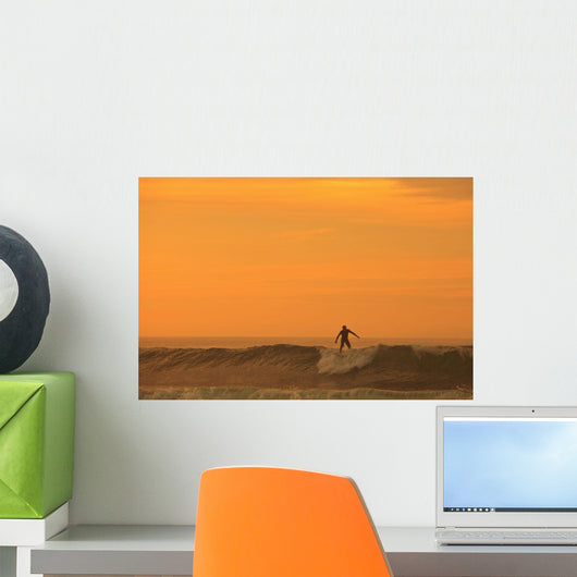 A Surfer On A Wave At Dusk Wall Mural