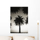 Silhouetted palm tree centered between other palm tree tops at dusk Wall Mural