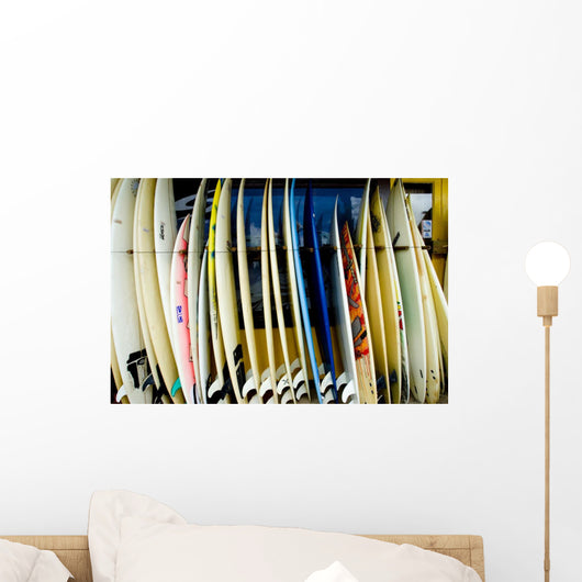 row of surfboards outside of a surfshop Wall Mural