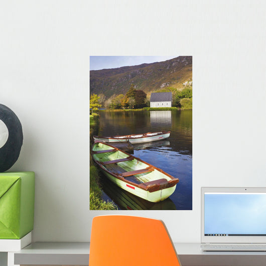 St Finbarre's Oratory And Rowing Boats On Shore Of Gougane Barra Lake Wall Mural