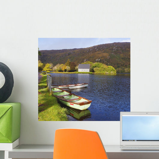 St Finbarre's Oratory And Rowing Boats On Shore Of Gougane Barra Lake Wall Mural