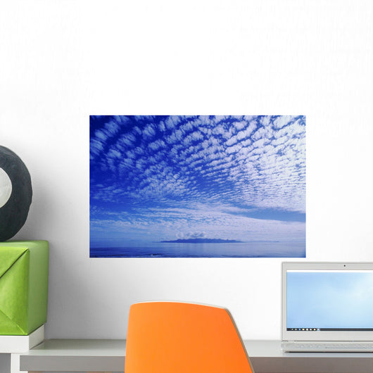 Cotton-Like Clouds In Blue Sky Over Smooth Ocean Water Wall Mural