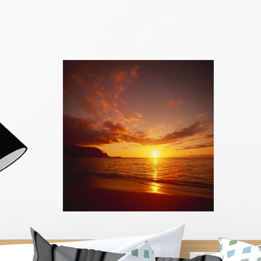 Calm Shoreline Ocean Waters With Orange Reflections From Sunset Wall Mural