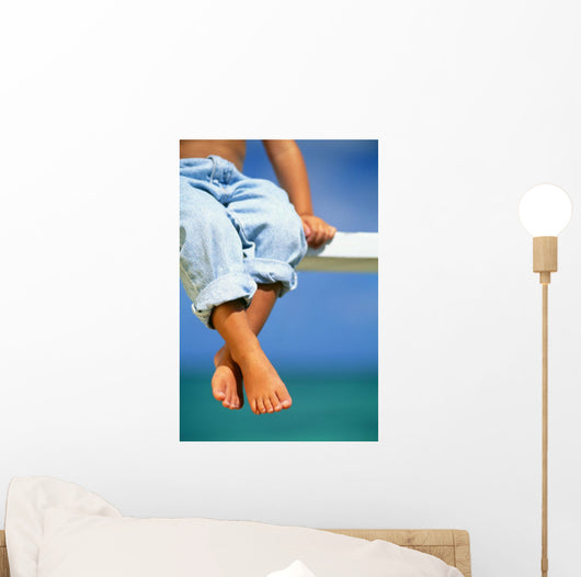 Hawaii, Legs And Feet Of Young Boy Sitting On A Bench By The Ocean Wall Mural