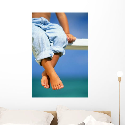 Hawaii, Legs And Feet Of Young Boy Sitting On A Bench By The Ocean Wall Mural
