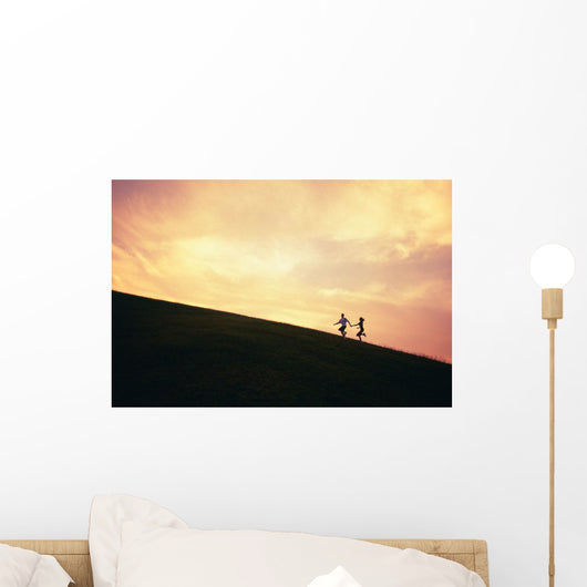Hawaii, Couple Running Along A Hill At Sunset Wall Mural