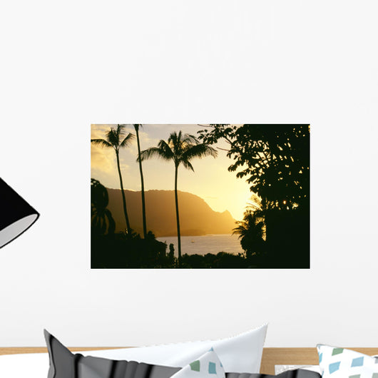 Yellow Sunset Through Palm Trees And Vegetation Wall Mural
