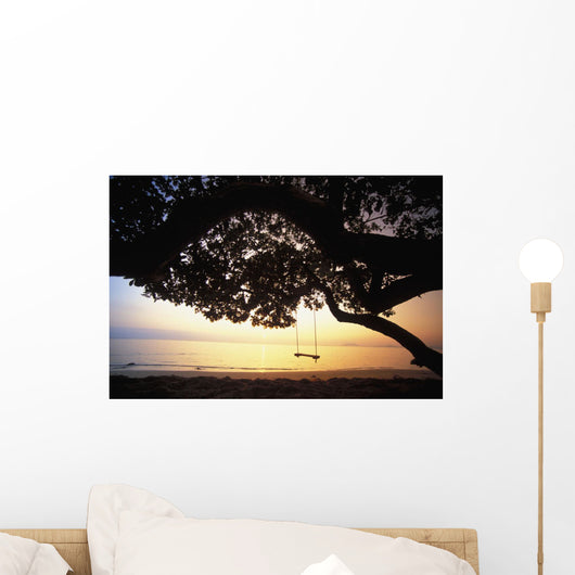 Tree Swing Silhouetted Against Beach And Calm Ocean At Sunrise Wall Mural