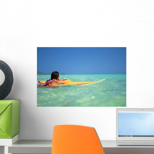 Woman Resting On Surfboard Looking Out On Clear Teal Water Wall Mural