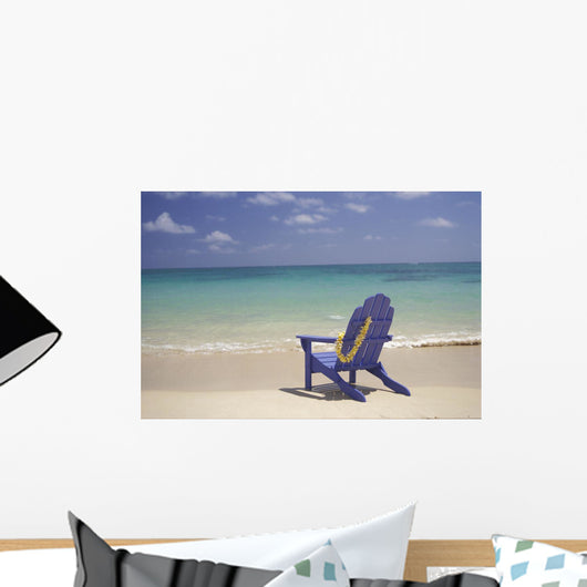 Plumeria Lei Hanging Over Blue Beach Chair Along Shoreline Wall Mural