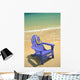 Blue Chair Along Shoreline With Plumeria Lei Hanging On Side Wall Mural
