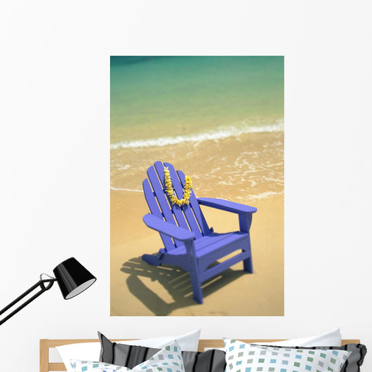 Blue Chair Along Shoreline With Plumeria Lei Hanging On Side Wall Mural
