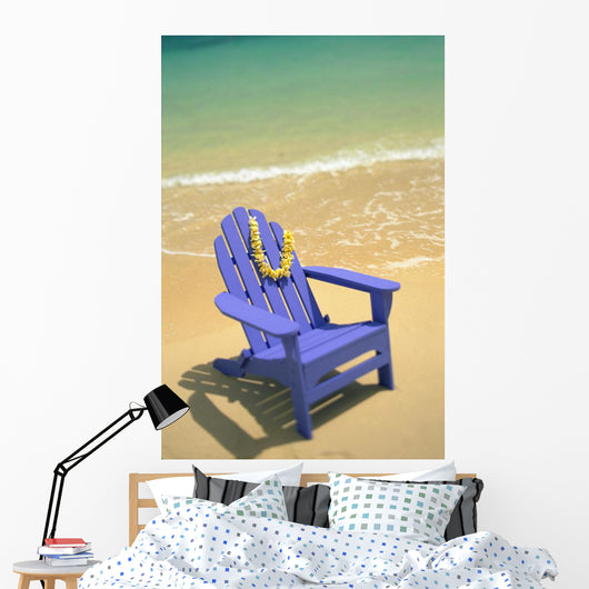 Blue Chair Along Shoreline With Plumeria Lei Hanging On Side Wall Mural
