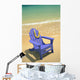 Blue Chair Along Shoreline With Plumeria Lei Hanging On Side Wall Mural