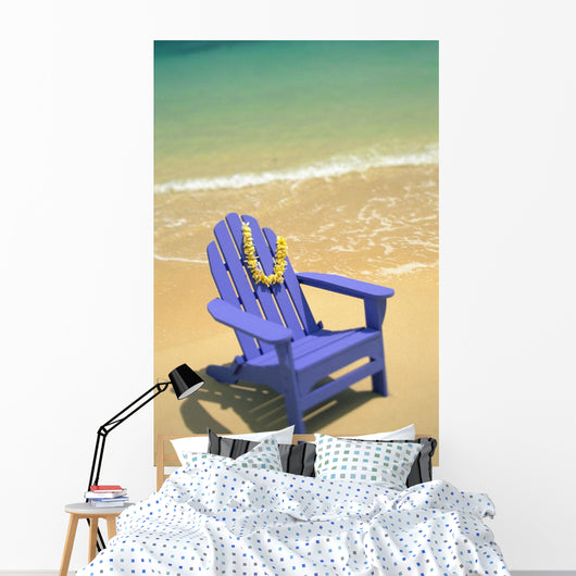 Blue Chair Along Shoreline With Plumeria Lei Hanging On Side Wall Mural