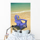 Blue Chair Along Shoreline With Plumeria Lei Hanging On Side Wall Mural