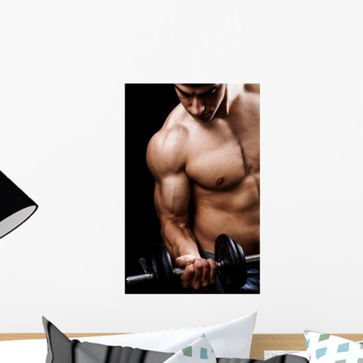 Powerful muscular man lifting weights Wall Mural
