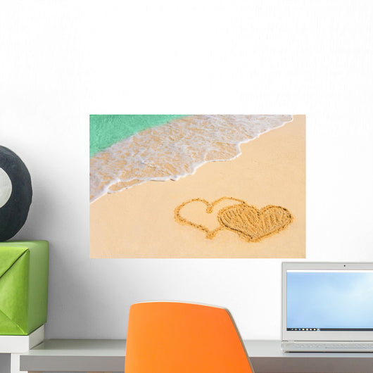 Drawing connected hearts on beach Wall Mural