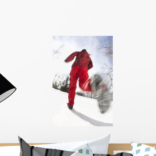 Low Angle View Of A Young Woman Jogging In Winter Wall Mural