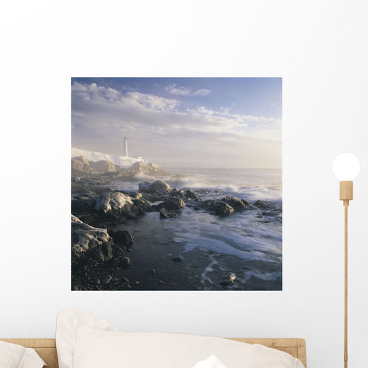 Fog And Rocky Shoreline In Winter With Cap Des Rosiers Lighthouse Wall Mural